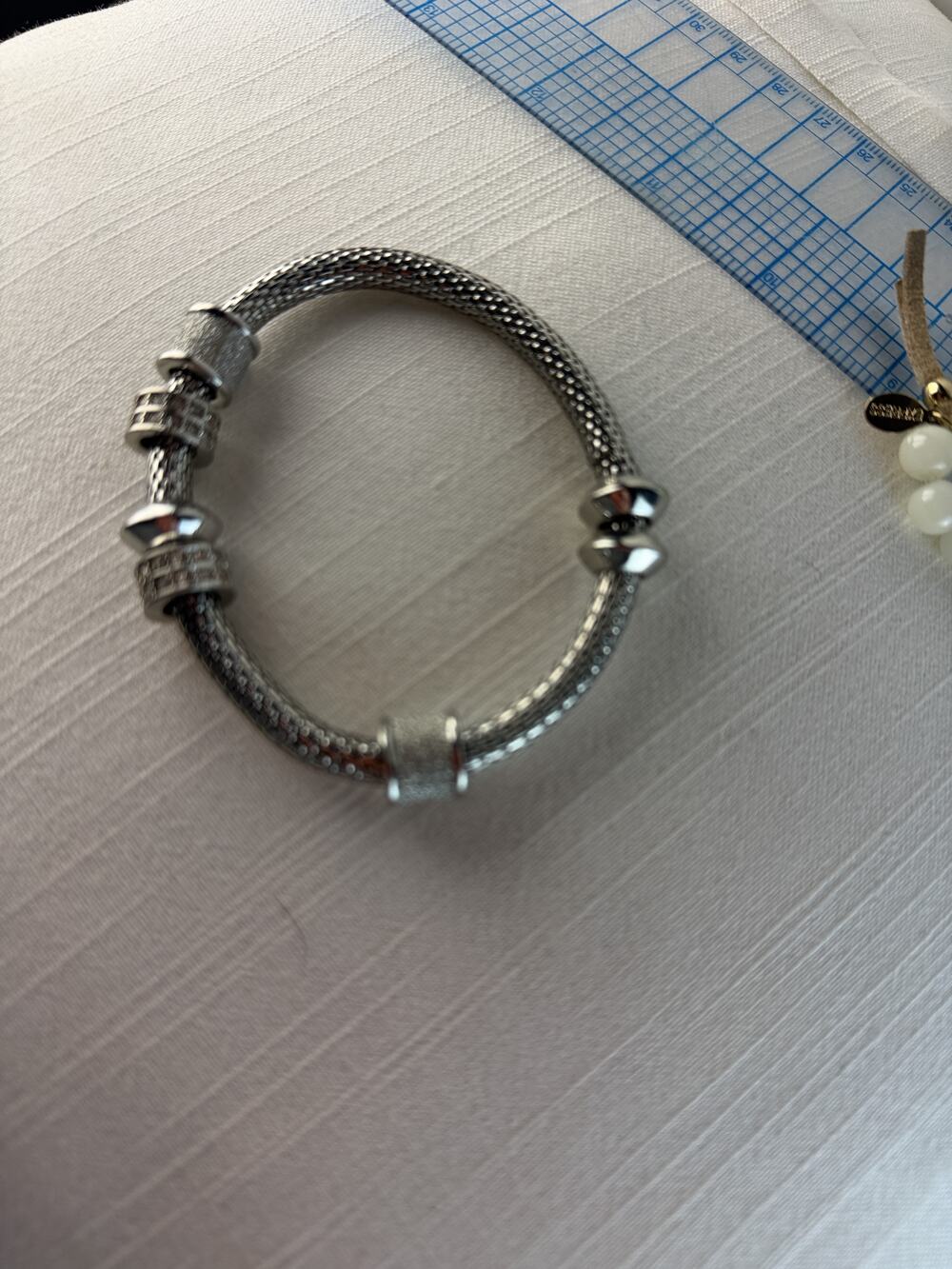 Silver tone braided mesh bangle bracelet with stacked spacer bead accents